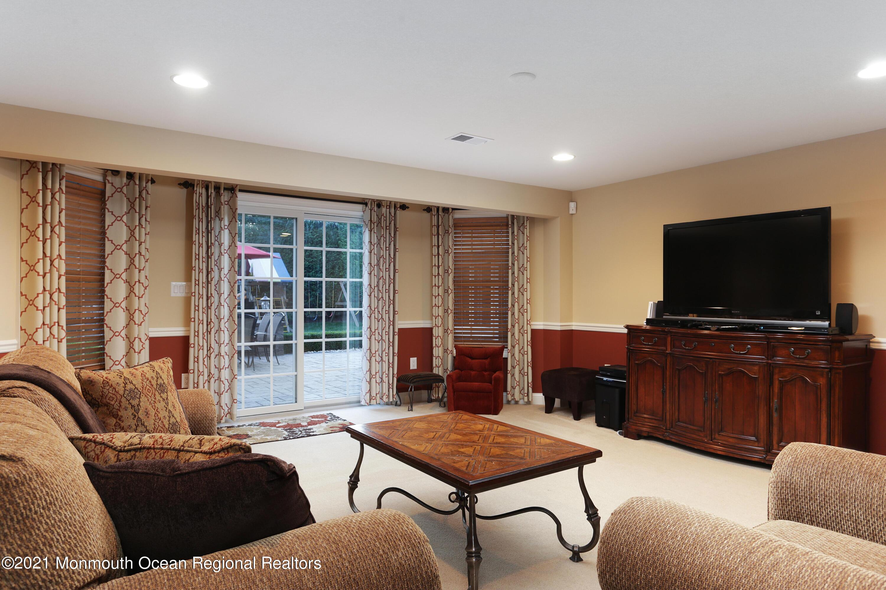4 Yorktown Road Morganville, NJ 07751 - Photo 38 of 64 a living room with furniture and a flat screen tv