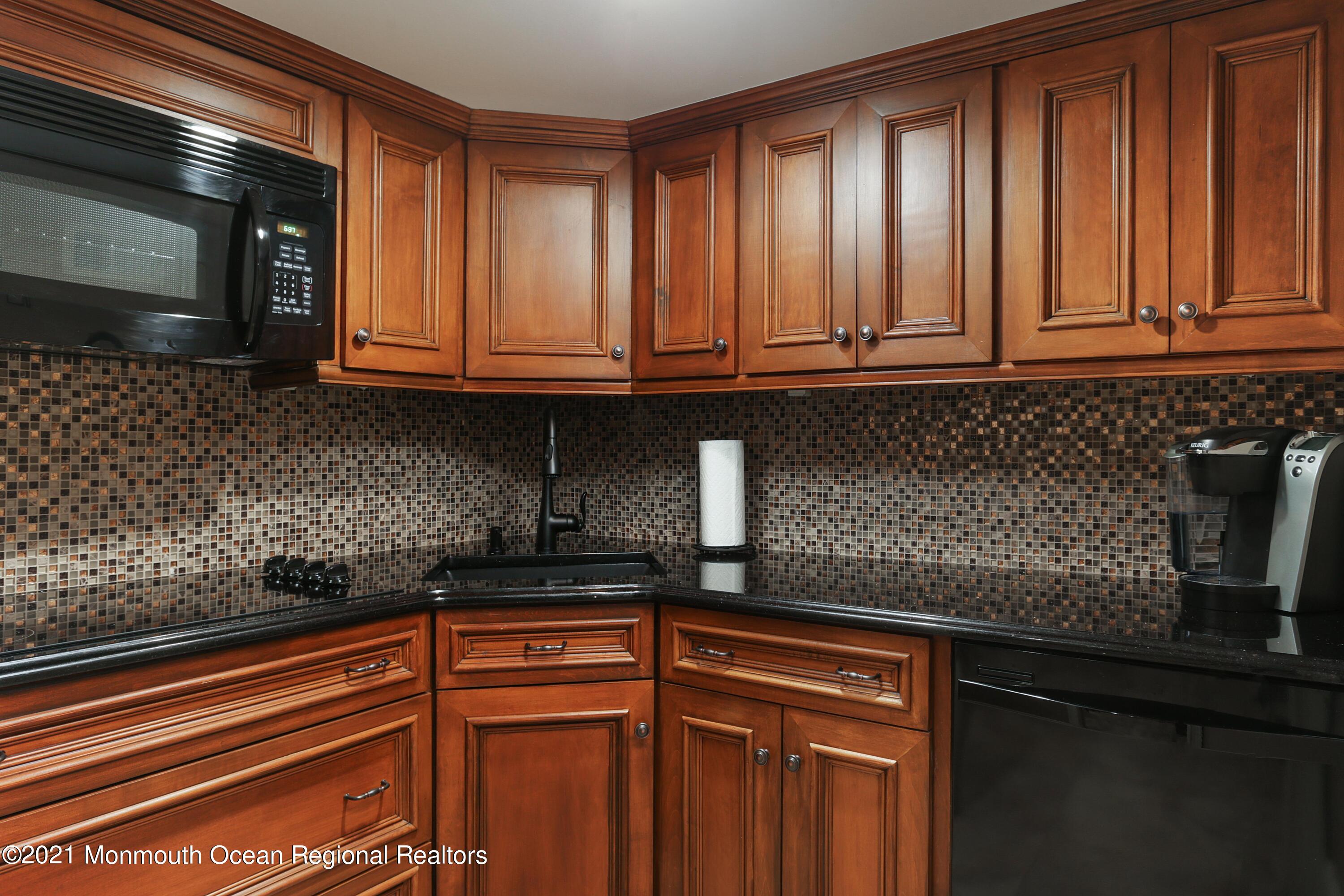 4 Yorktown Road Morganville, NJ 07751 - Photo 40 of 64 a kitchen with granite countertop cabinets and a microwave oven