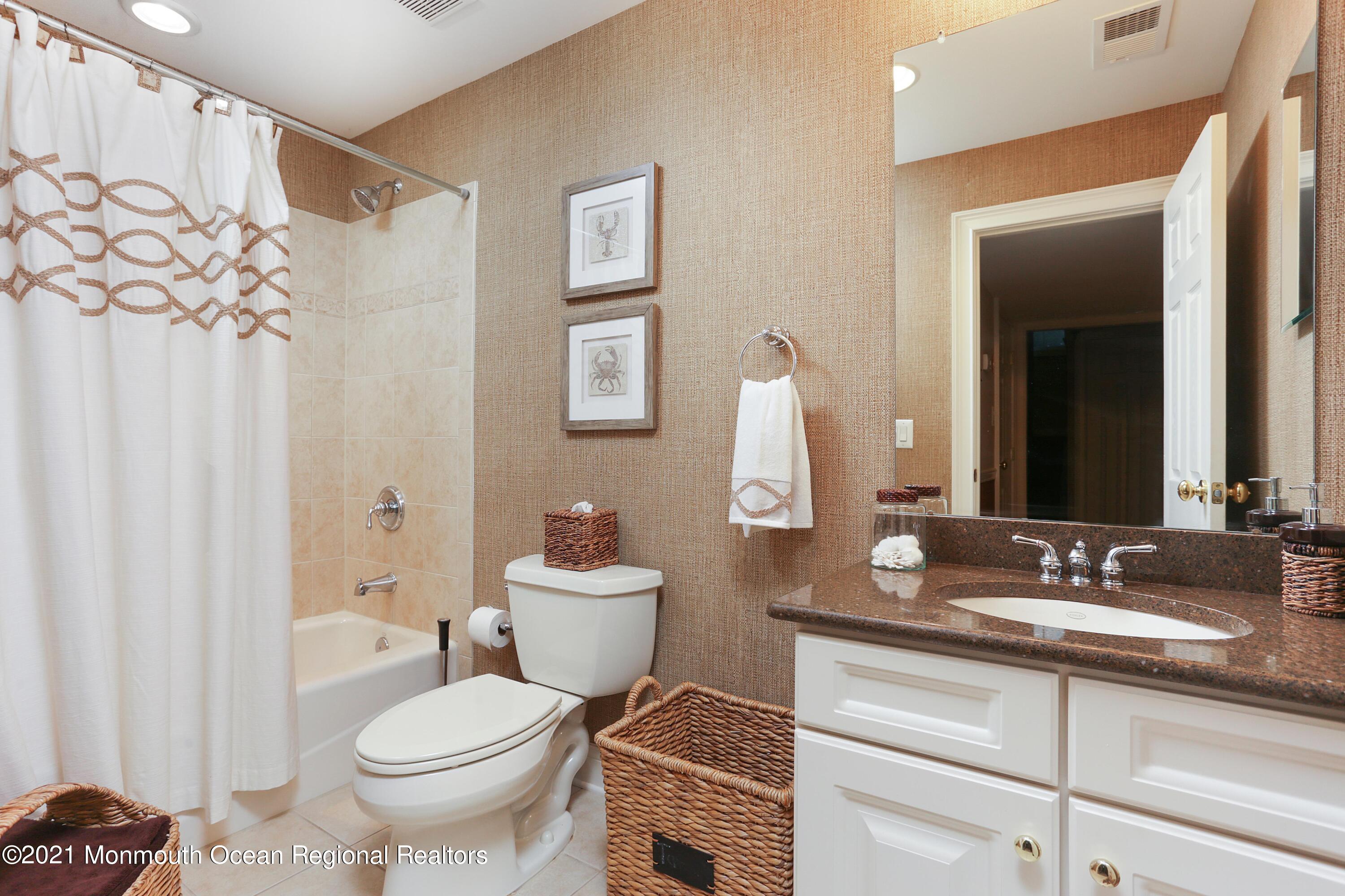 4 Yorktown Road Morganville, NJ 07751 - Photo 42 of 64 a bathroom with a toilet sink and mirror