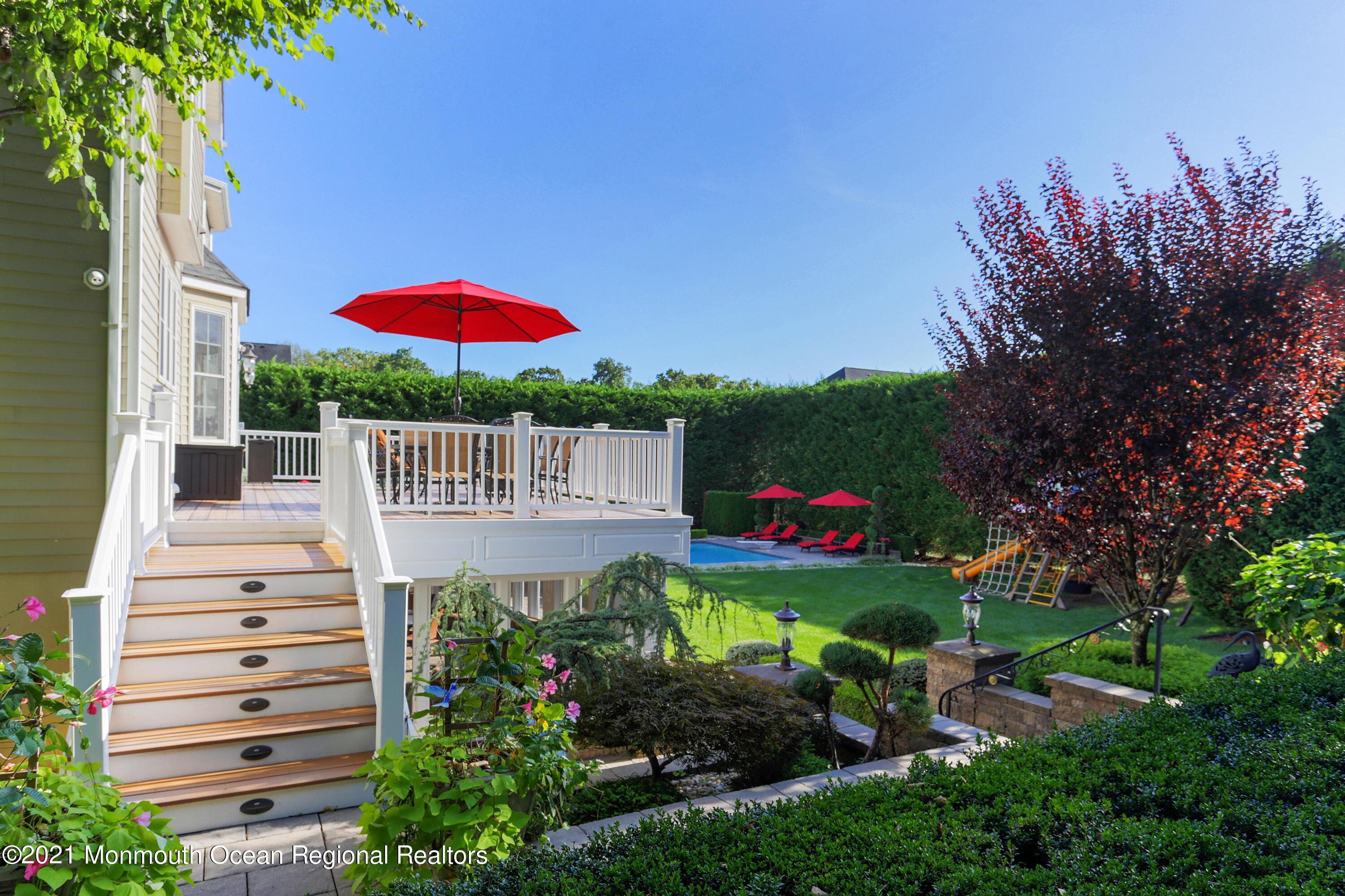 4 Yorktown Road Morganville, NJ 07751 - Photo 45 of 64 a front view of a house with a yard and outdoor seating