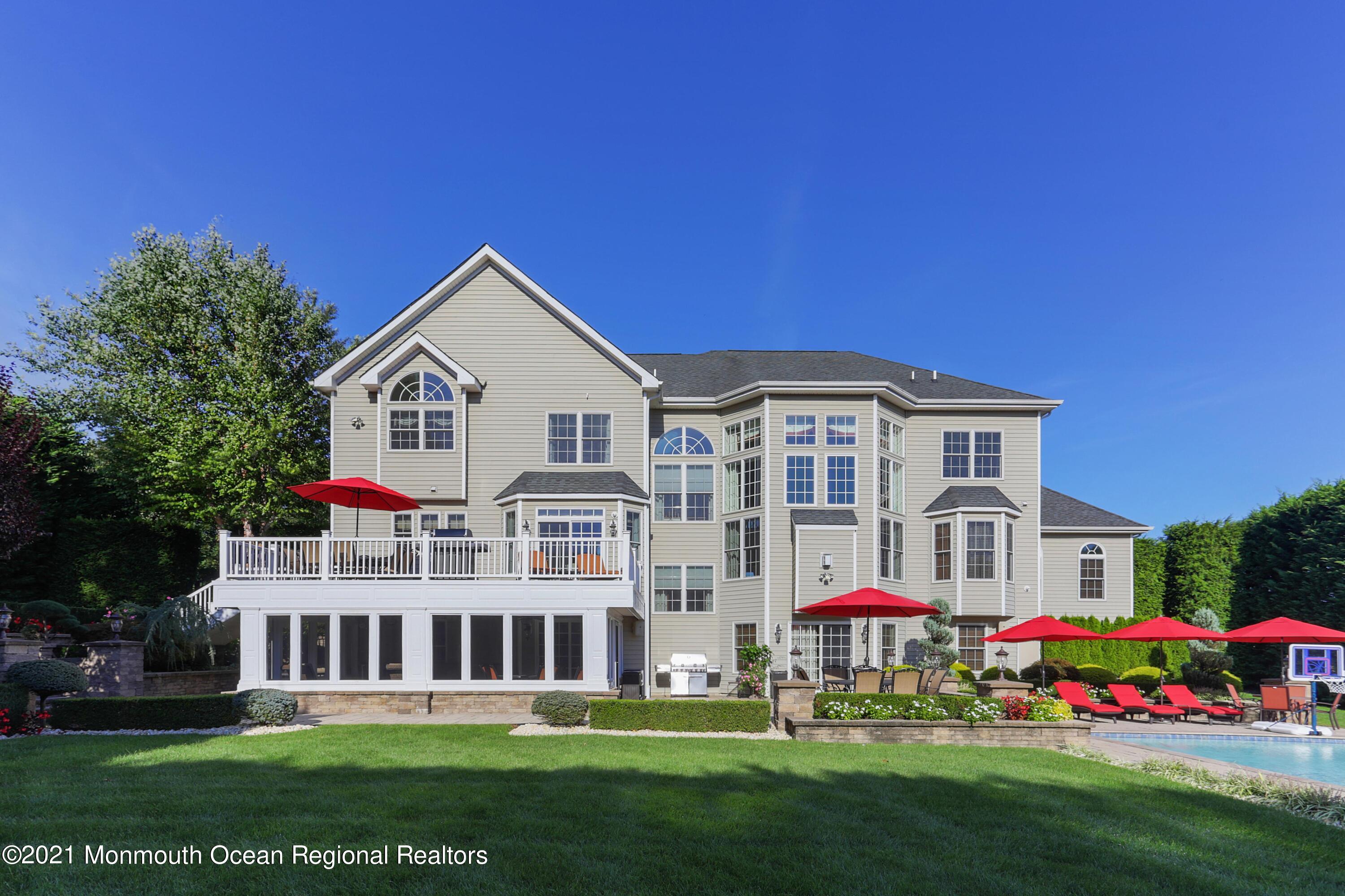 4 Yorktown Road Morganville, NJ 07751 - Photo 47 of 64 a front view of residential houses with yard and green space