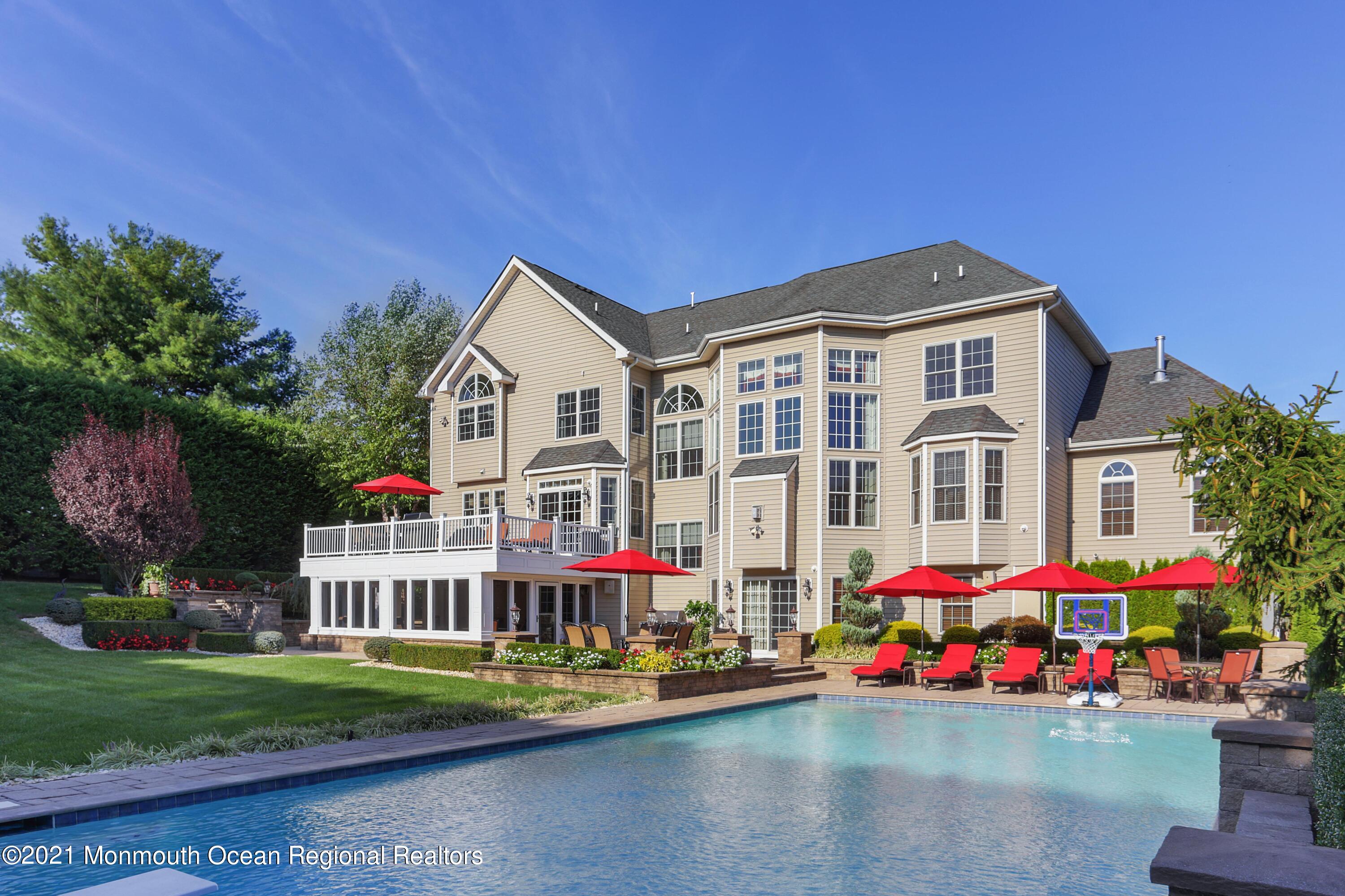 4 Yorktown Road Morganville, NJ 07751 - Photo 50 of 64 a front view of a house with a yard and fountain