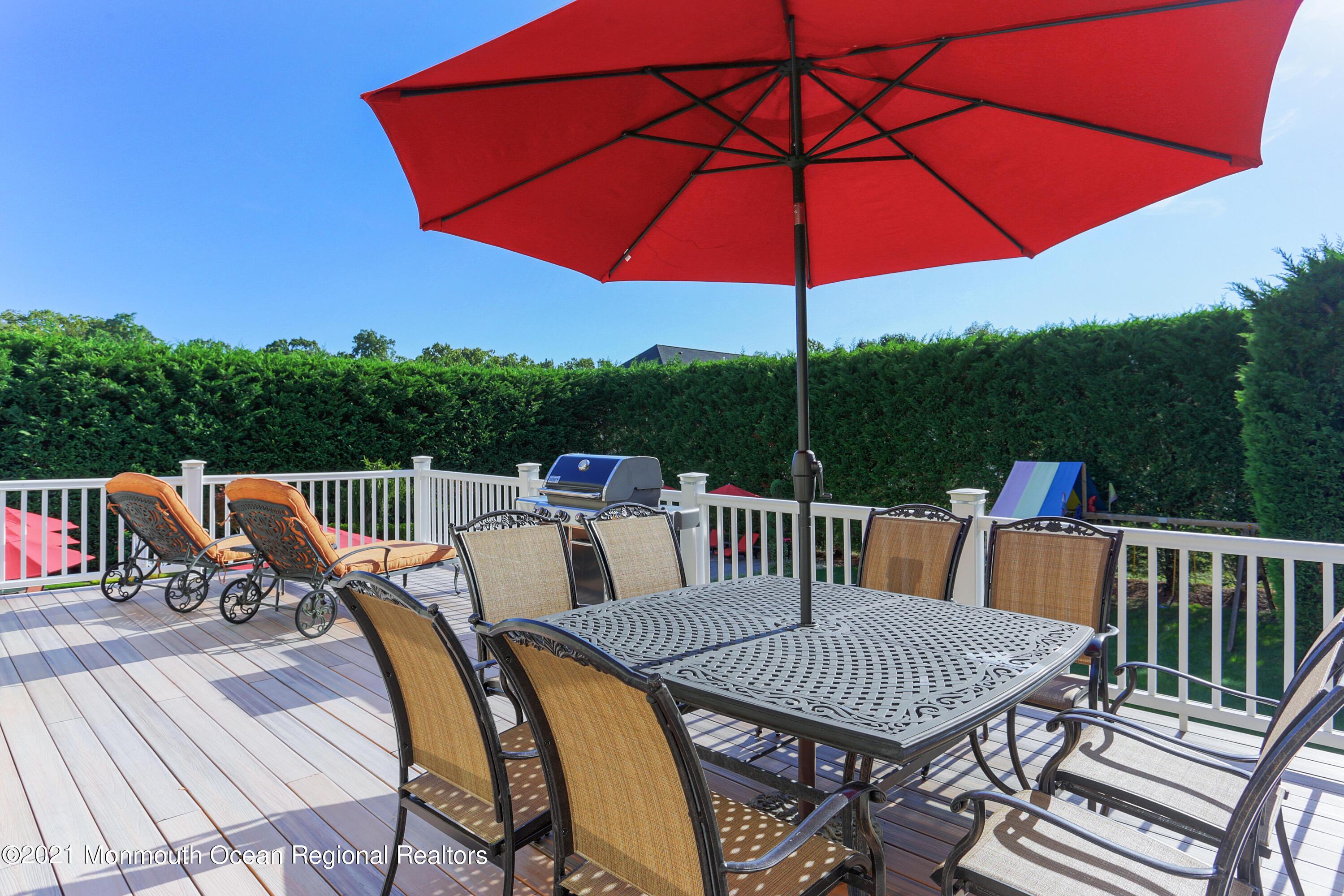 4 Yorktown Road Morganville, NJ 07751 - Photo 54 of 64 a view of a patio with a table chairs and umbrella