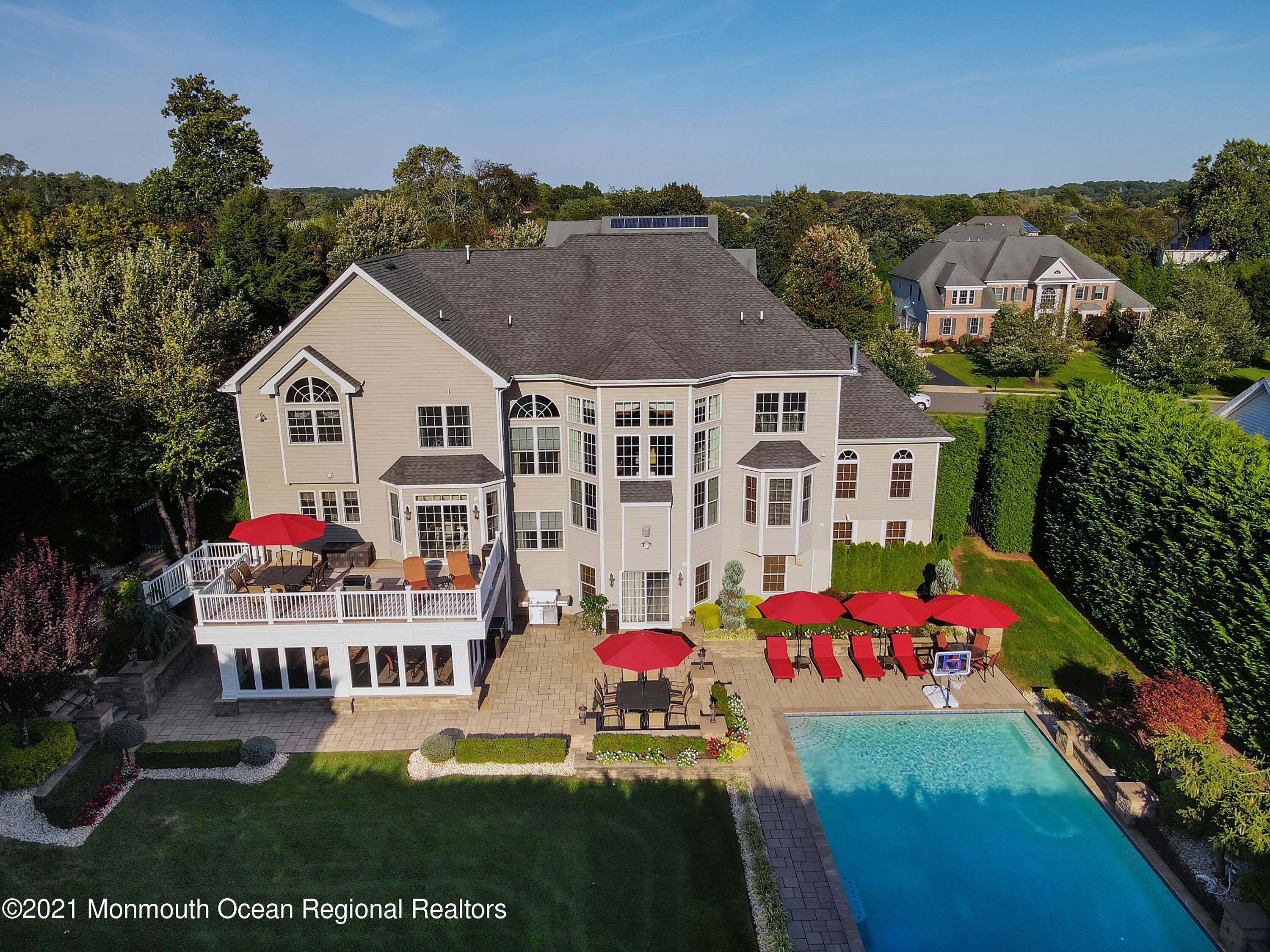 4 Yorktown Road Morganville, NJ 07751 - Photo 56 of 64 an aerial view of residential houses with outdoor space and lakeside
