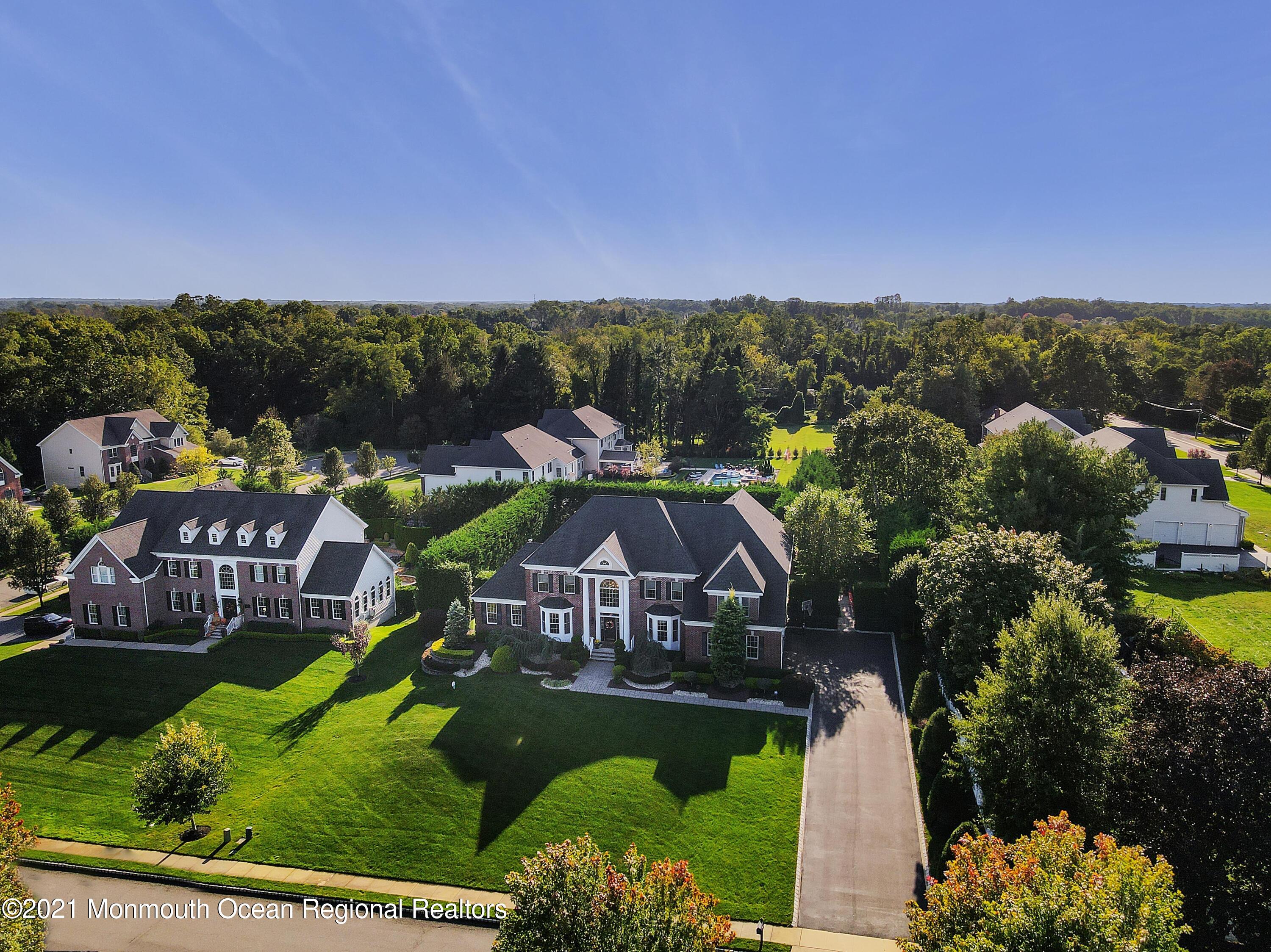 4 Yorktown Road Morganville, NJ 07751 - Photo 61 of 64 an aerial view of a house with a garden and lake view