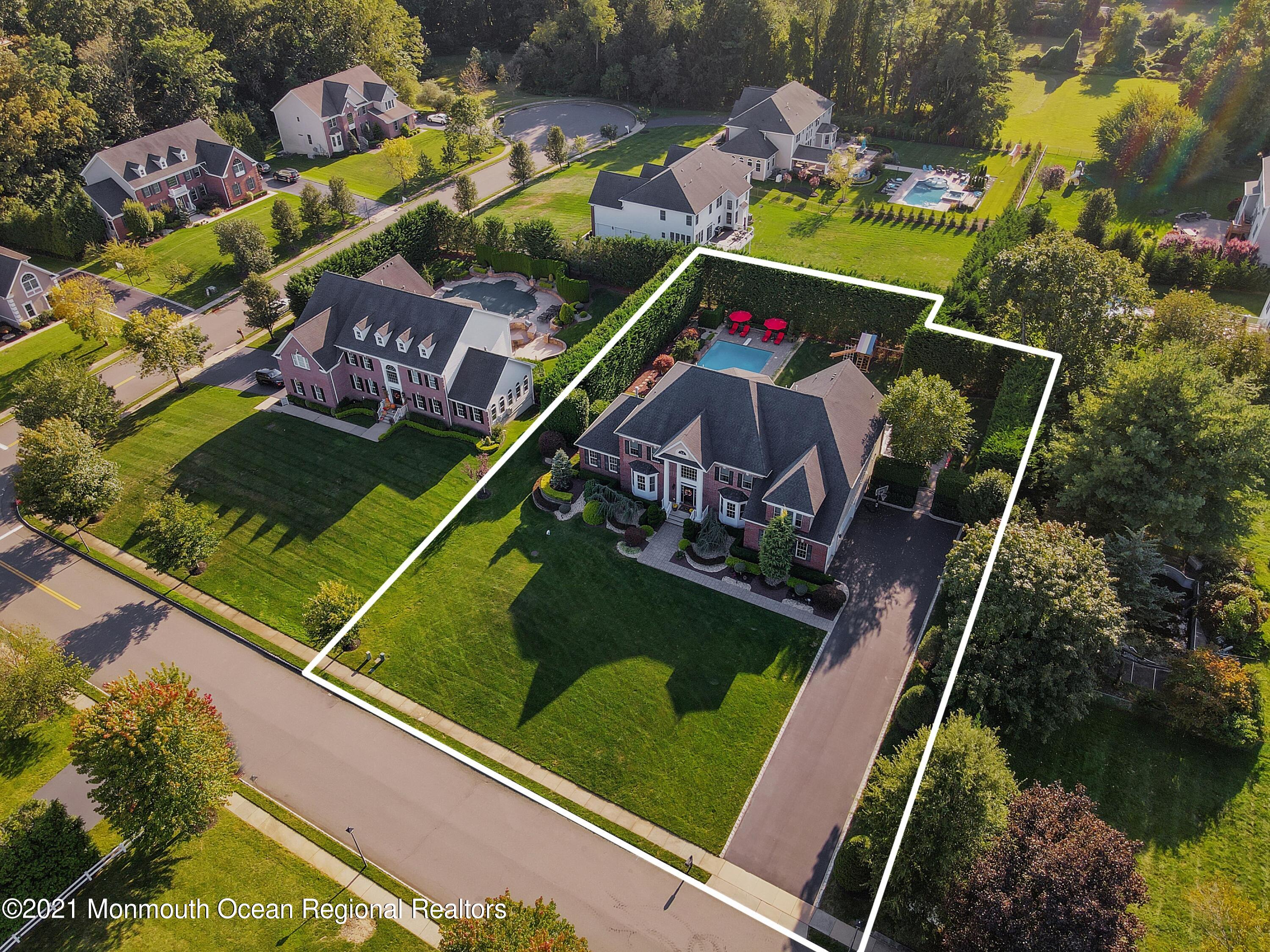4 Yorktown Road Morganville, NJ 07751 - Photo 63 of 64 an aerial view of a tennis ground and a cars park side of the road