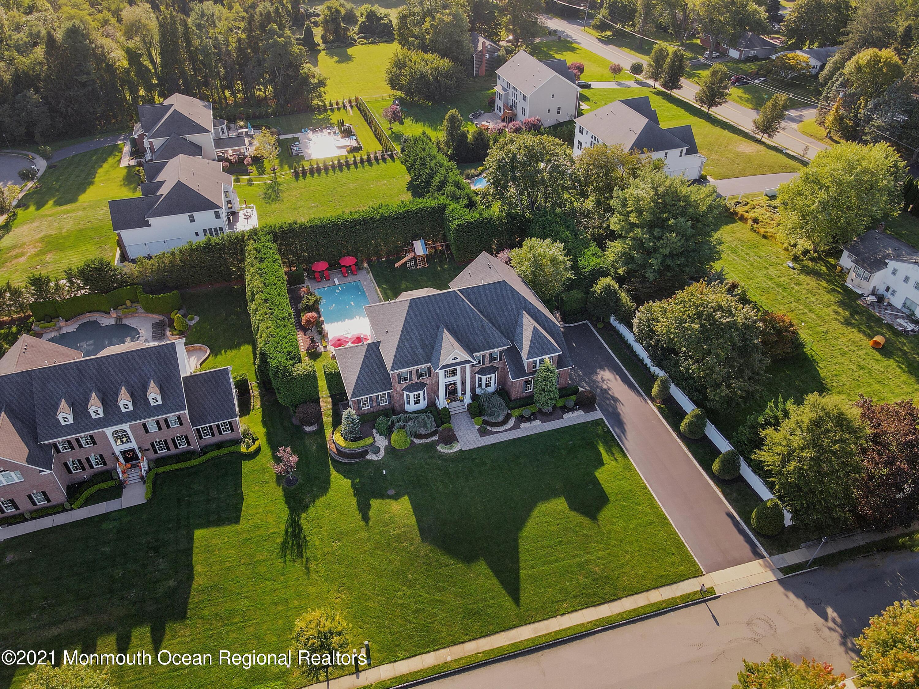 4 Yorktown Road Morganville, NJ 07751 - Photo 64 of 64 an aerial view of residential houses with outdoor space and swimming pool