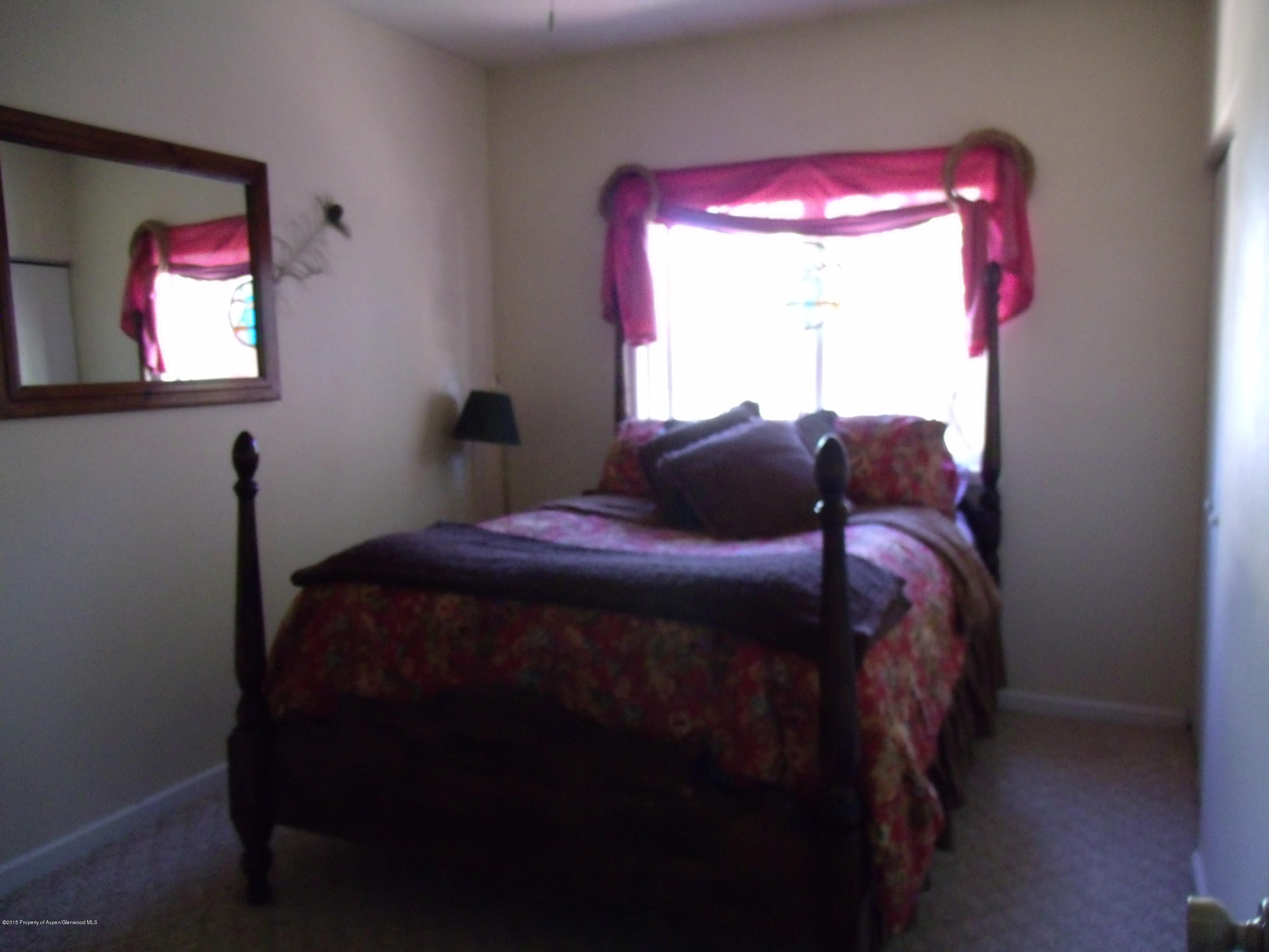 570 Elm Court Rifle, CO 81650 - Photo 11 of 15 a bedroom with a bed and a window