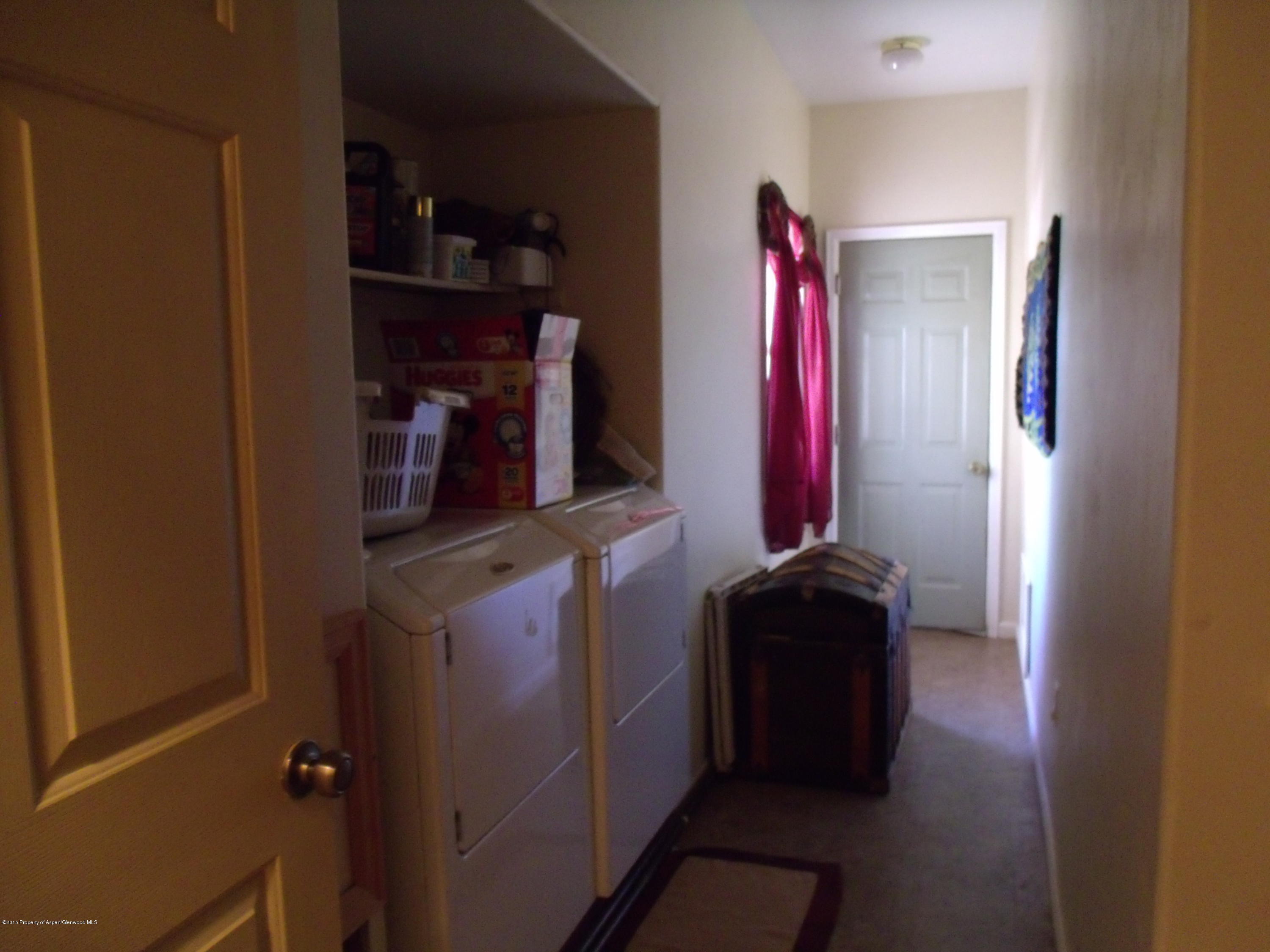 570 Elm Court Rifle, CO 81650 - Photo 8 of 15 a kitchen with a refrigerator and a wooden floor