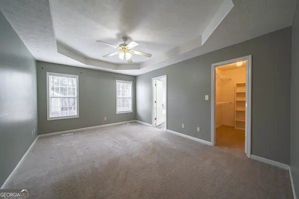 an empty room with windows and closet