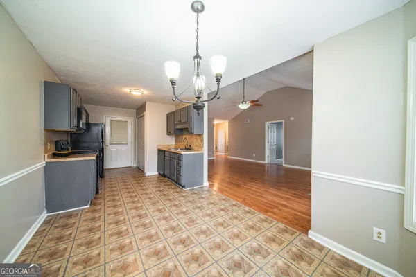 a kitchen with granite countertop a refrigerator and a sink