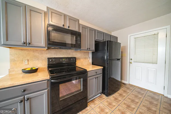 a kitchen with granite countertop wooden cabinets and stainless steel appliances