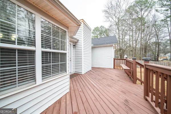 a balcony with wooden floor and fence