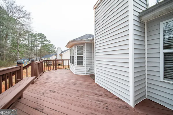 a view of a balcony with wooden floor and fence