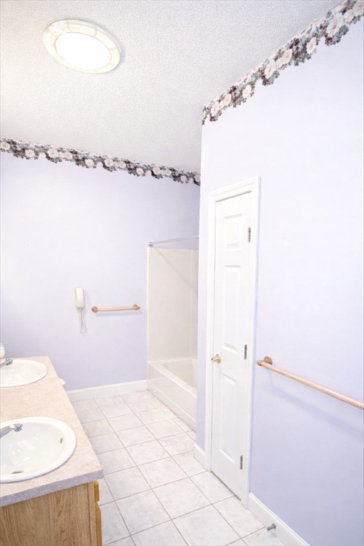 9 Arbor Road, Unit 9 Dracut, MA 01826 - Photo 11 of 27 a bathroom with a shower and a toilet