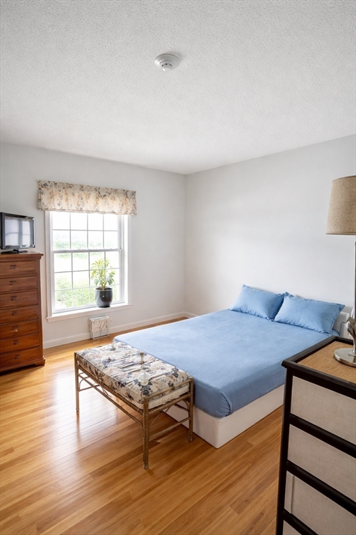 9 Arbor Road, Unit 9 Dracut, MA 01826 - Photo 12 of 27 a bed room with a bed and a window