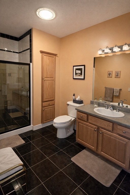 9 Arbor Road, Unit 9 Dracut, MA 01826 - Photo 13 of 27 a bathroom with a double vanity sink toilet and shower