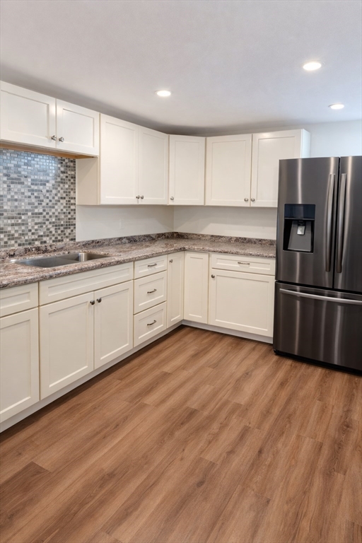 9 Arbor Road, Unit 9 Dracut, MA 01826 - Photo 16 of 27 a kitchen with granite countertop a refrigerator sink and cabinets