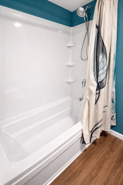 9 Arbor Road, Unit 9 Dracut, MA 01826 - Photo 18 of 27 a bathroom with a bathtub and a shower