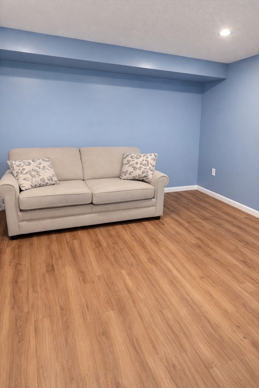 9 Arbor Road, Unit 9 Dracut, MA 01826 - Photo 19 of 27 a living room with a couch