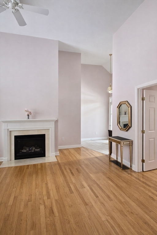 9 Arbor Road, Unit 9 Dracut, MA 01826 - Photo 2 of 27 a living room with a fireplace wooden floor and a fireplace