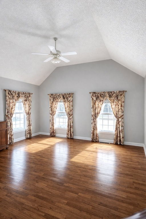 9 Arbor Road, Unit 9 Dracut, MA 01826 - Photo 8 of 27 an empty room with wooden floor chandelier fan and windows