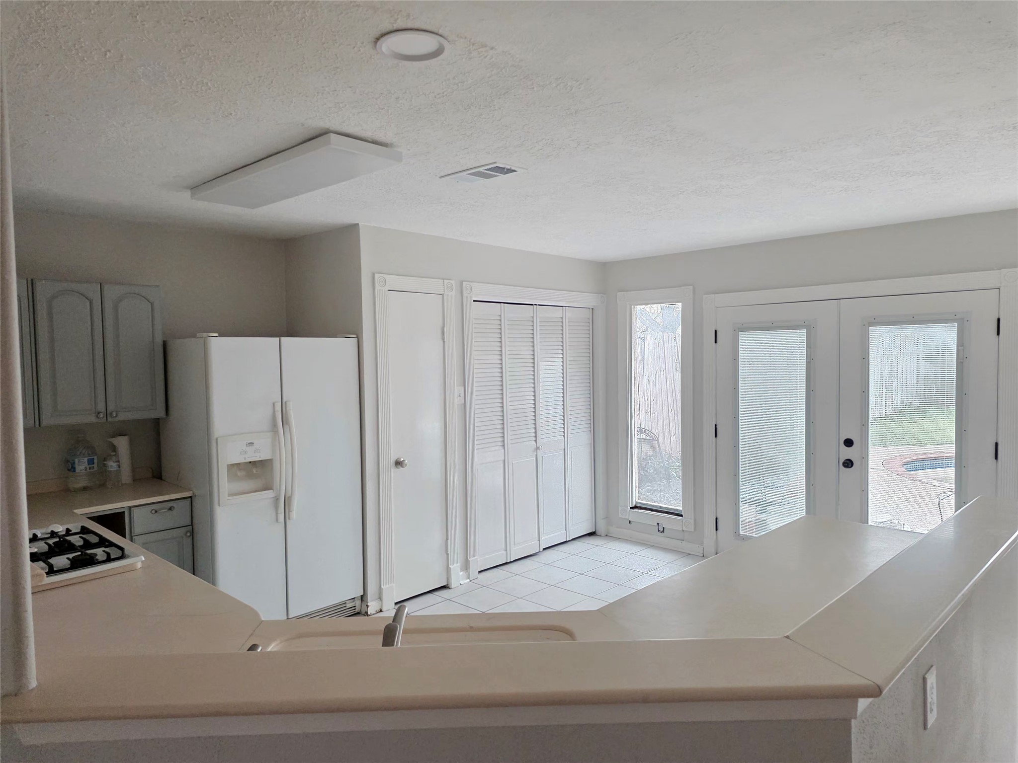2443 Spring Dusk Drive Spring, TX 77373 - Photo 3 of 11 a view of a kitchen with a sink and refrigerator