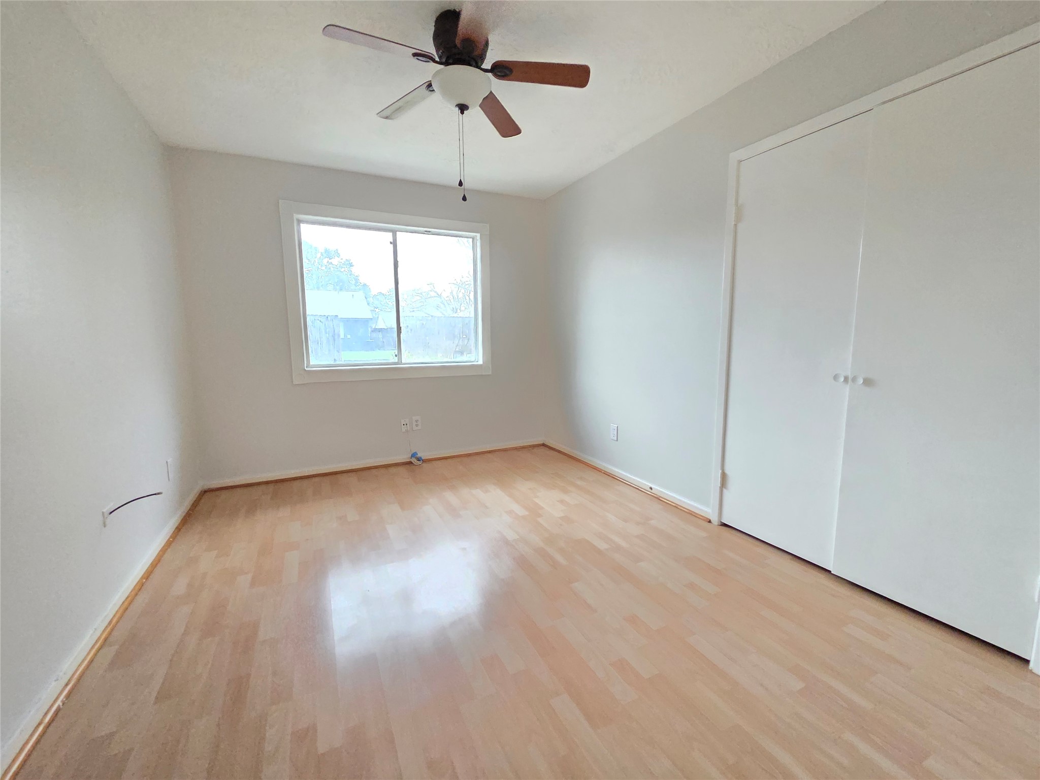 2443 Spring Dusk Drive Spring, TX 77373 - Photo 4 of 11 wooden floor in an empty room with a window
