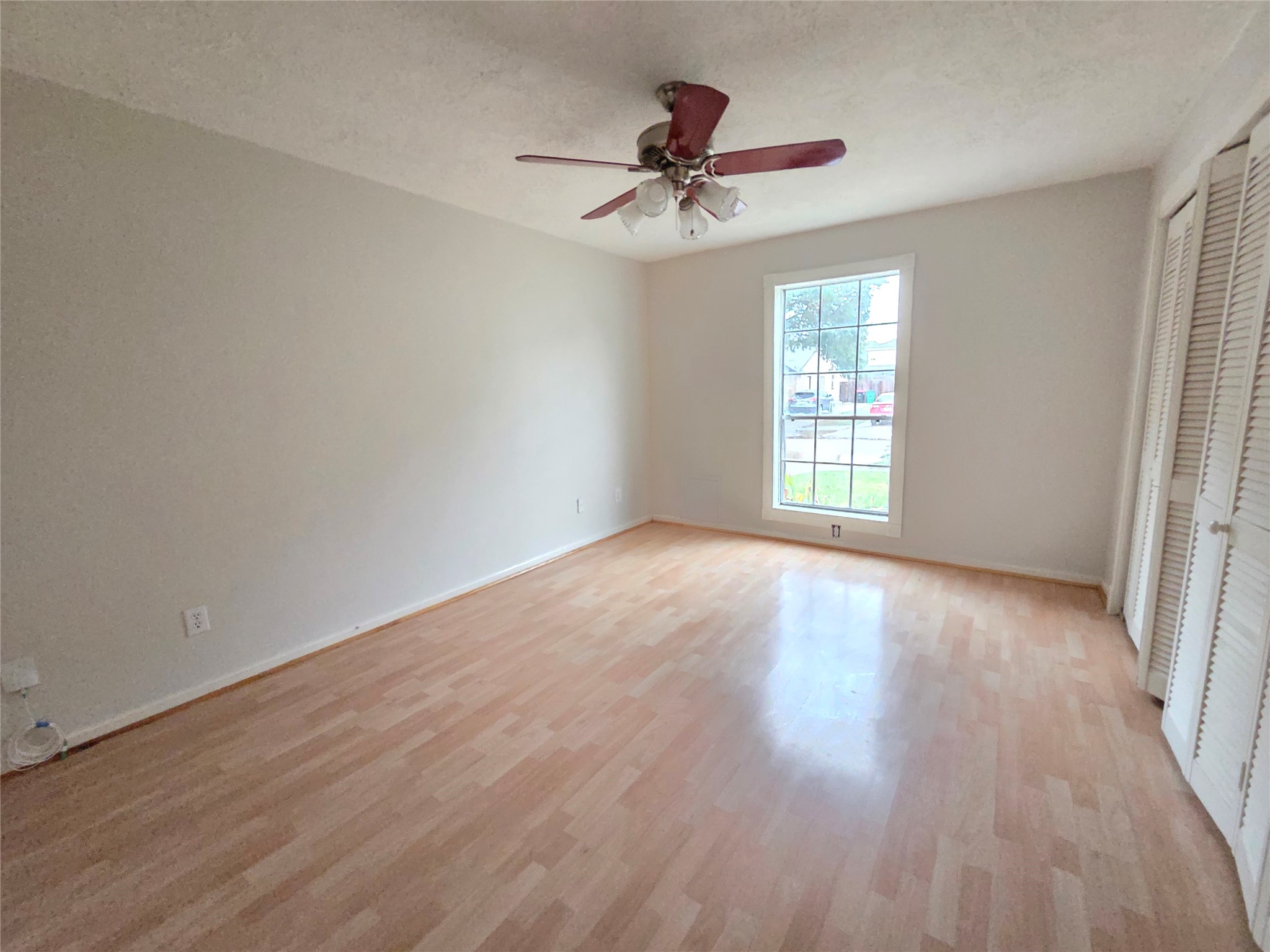 2443 Spring Dusk Drive Spring, TX 77373 - Photo 5 of 11 a view of an empty room with wooden floor and a window
