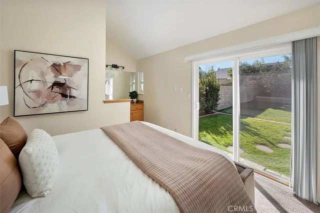 a bedroom with a large bed and a painting on the wall