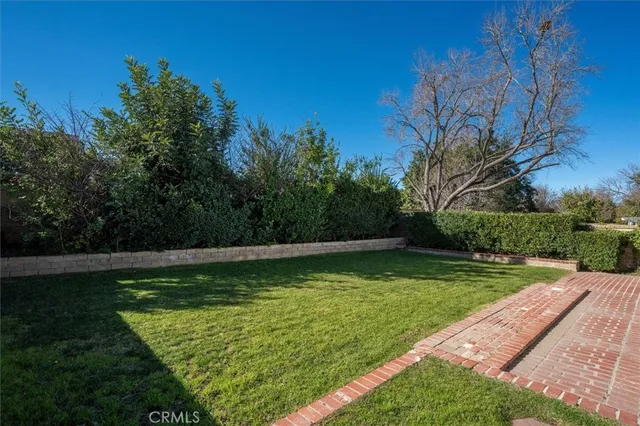 a view of a swimming pool with a yard
