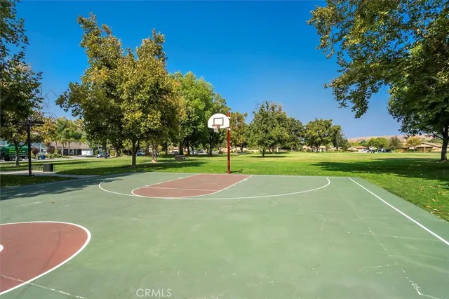 a view of a playground with basketball court