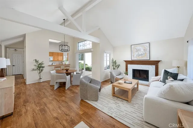 a living room with furniture a fireplace and a table