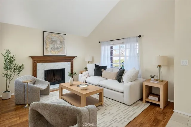 a living room with furniture a fireplace and a potted plant