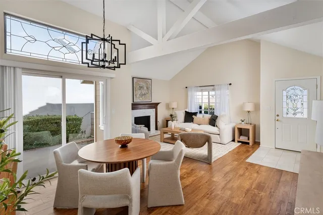 a view of a dining room with furniture wooden floor and chandelier