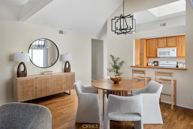 a dining room with furniture a potted plant and a chandelier