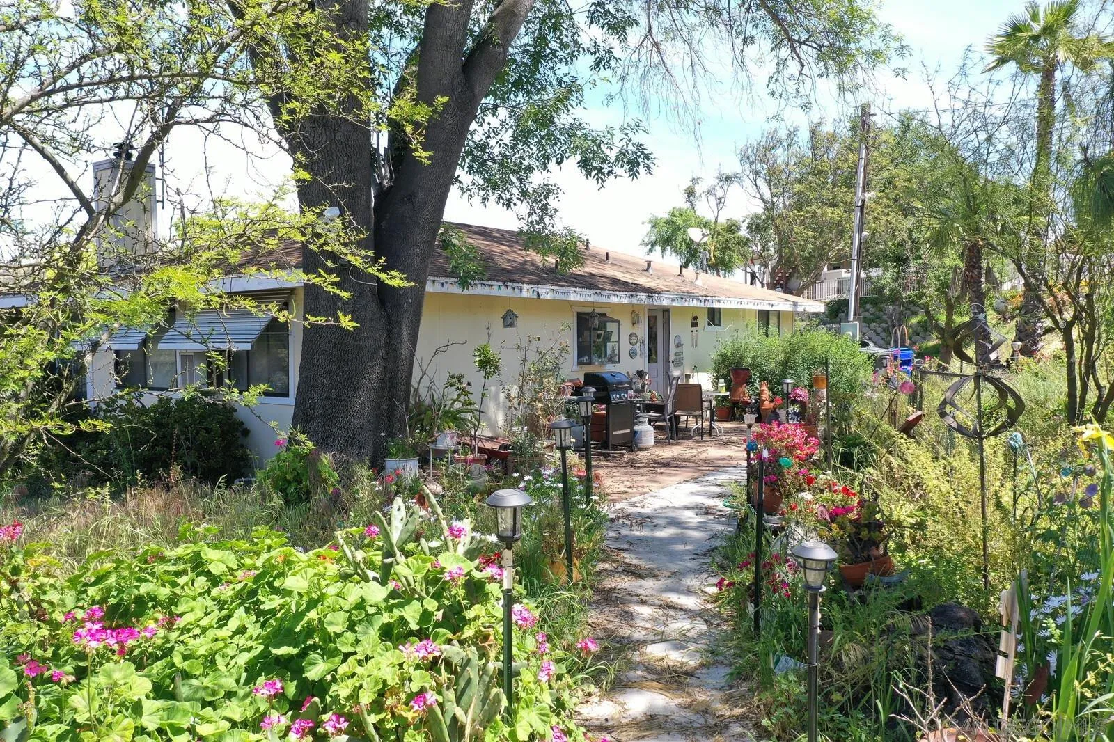 28555 Gordon Hill Road Valley Center, CA 92082 - Photo 1 of 10 a backyard of a house with yard and outdoor seating