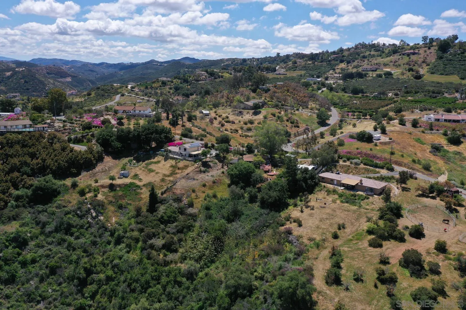 28555 Gordon Hill Road Valley Center, CA 92082 - Photo 3 of 10 an aerial view of a houses with a yard and mountain view in back