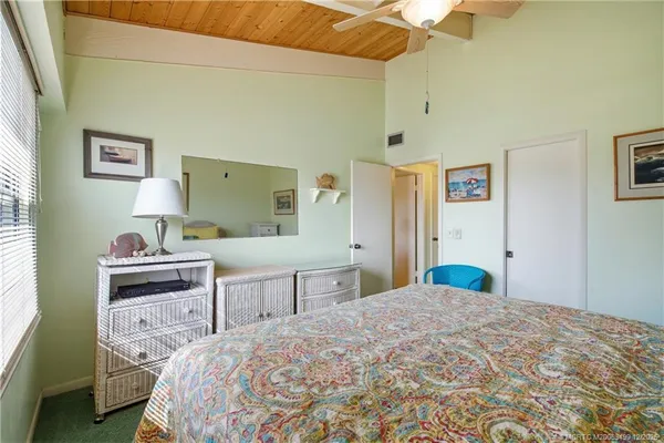 a bedroom with a bed and a television