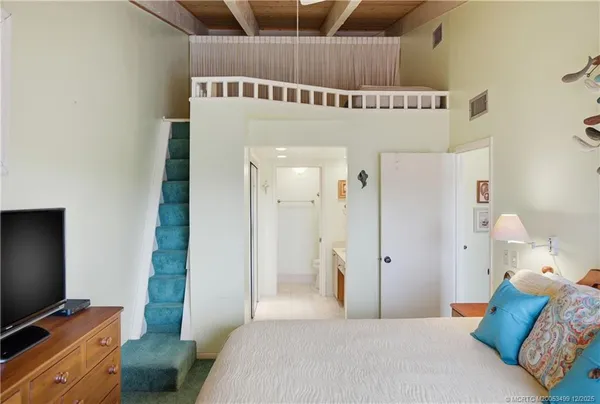 a view of a room with wooden stairs