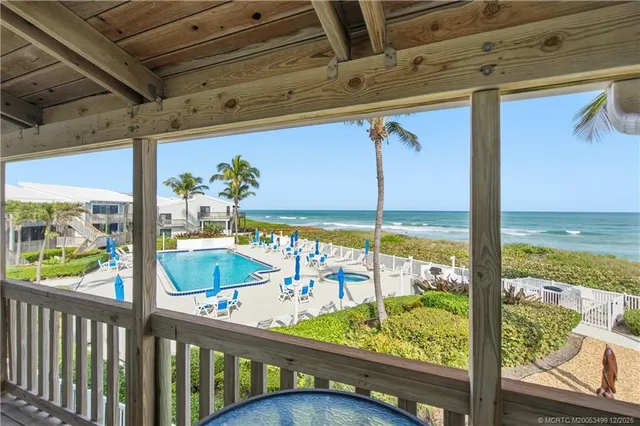 a view of a balcony with ocean view
