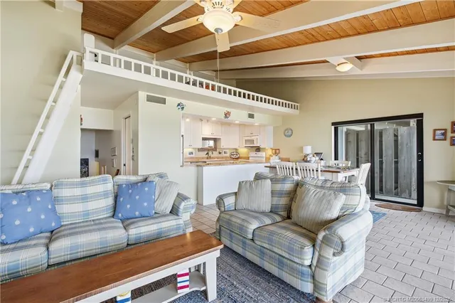 a dining room with furniture and a chandelier