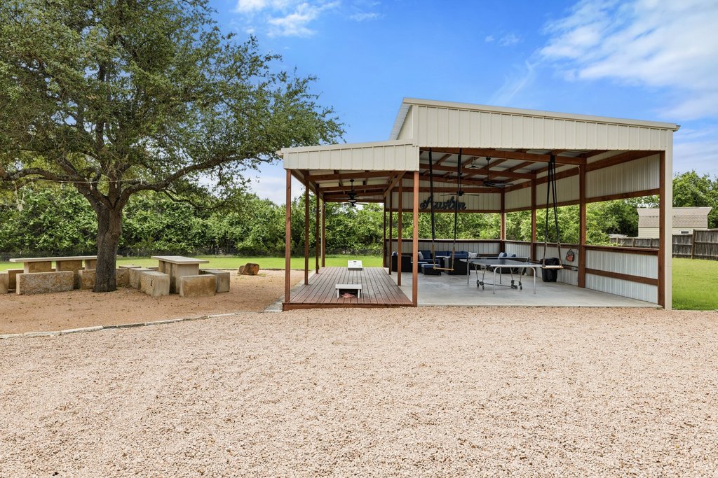 12135 Fitzhugh Road Austin, TX 78736 - Photo 21 of 30 a view of a house with backyard and porch