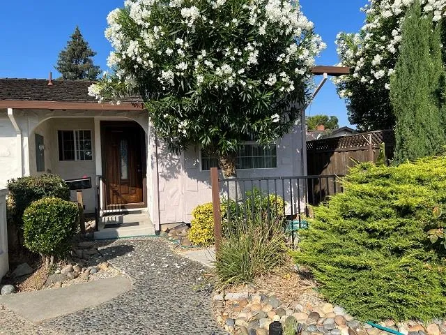 a front view of a house with garden