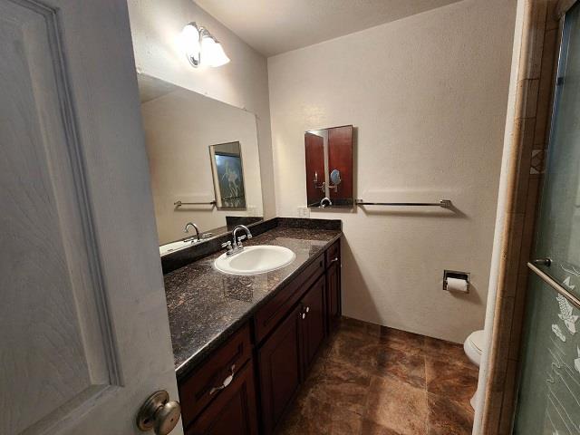 1652 Town Club Drive San Jose, CA 95124 - Photo 7 of 8 a bathroom with a granite countertop sink and a mirror