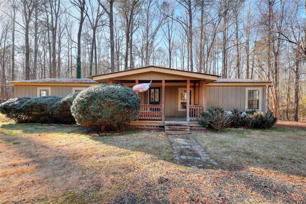 a backyard of a house with yard and outdoor seating