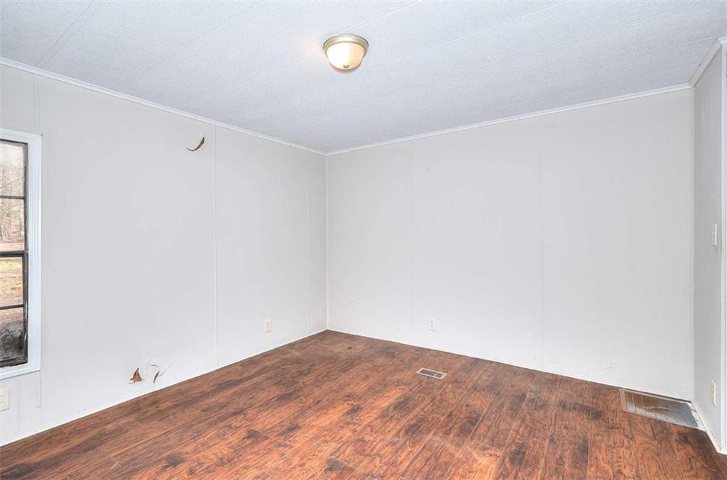 1210 Lee Peters Road Loganville, GA 30052 - Photo 16 of 32 a view of a room with wooden floor