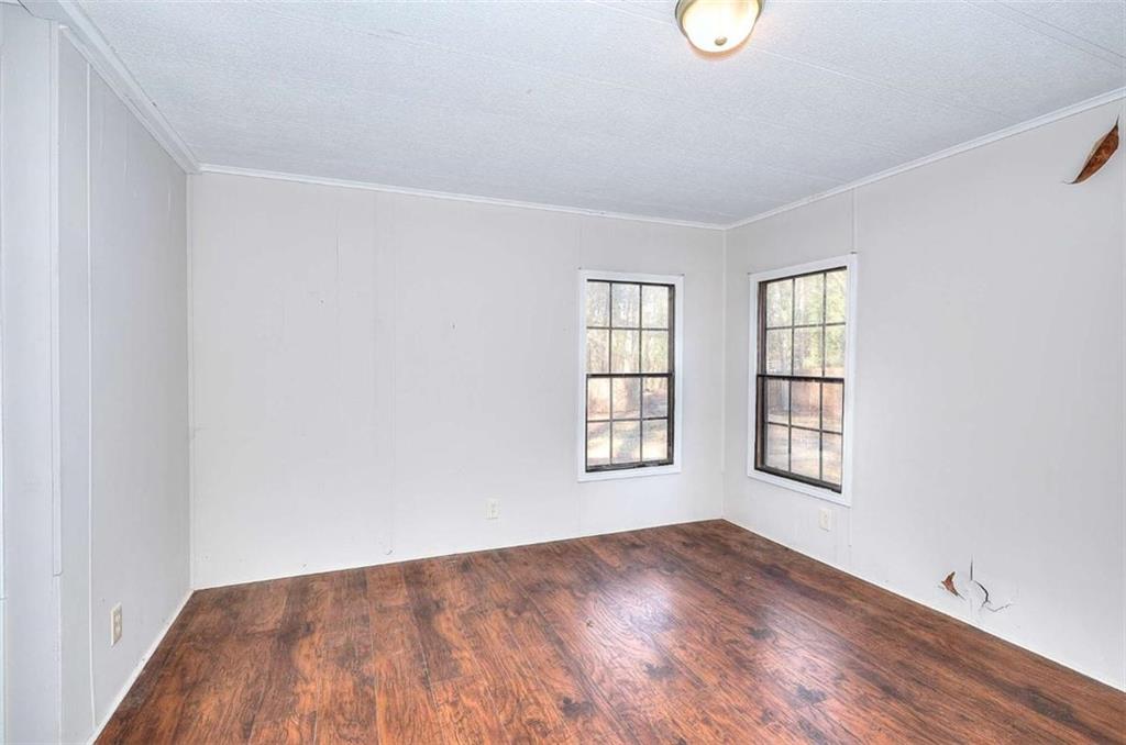 1210 Lee Peters Road Loganville, GA 30052 - Photo 18 of 32 an empty room with windows and cabinet