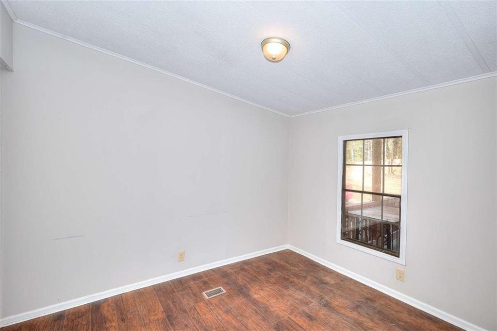 1210 Lee Peters Road Loganville, GA 30052 - Photo 19 of 32 an empty room with windows