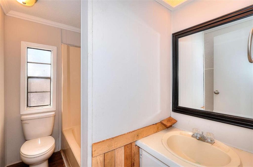 1210 Lee Peters Road Loganville, GA 30052 - Photo 23 of 32 a bathroom with a granite countertop sink toilet and mirror